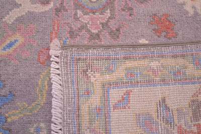 Detail of handknotted pile of field of grey and pastel toned Oushak Rug  and also reverse of rug showing knotting and weave.