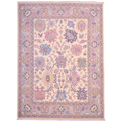 Handmade Oushak rug with cream base and mauve, blue, and pink floral medallions.