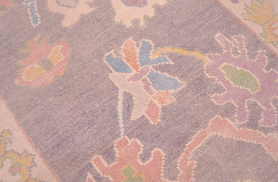 Detail of floral field of handmade runner with soft grey ground colour ans pastel palmettes