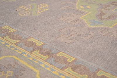 Grey Oushak carpet detail with yellow stripe-like pattern and light blue accents