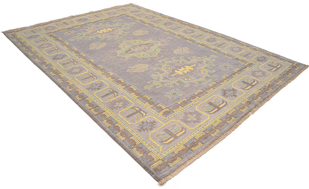 Corner view of grey Oushak carpet with yellow geometric detailing and thin border