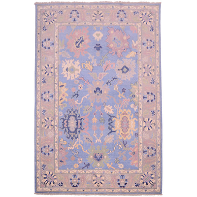 Afghan Oushak carpet with blue field, grey border punctuated with details of navy, green, yellow, and lilac.