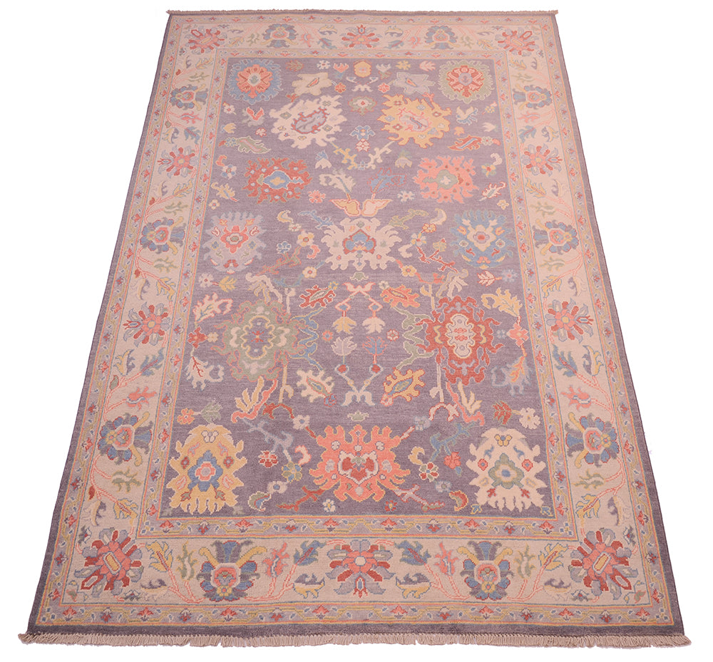 View of grey, cream, blue and terracotta carpet in oushak design.