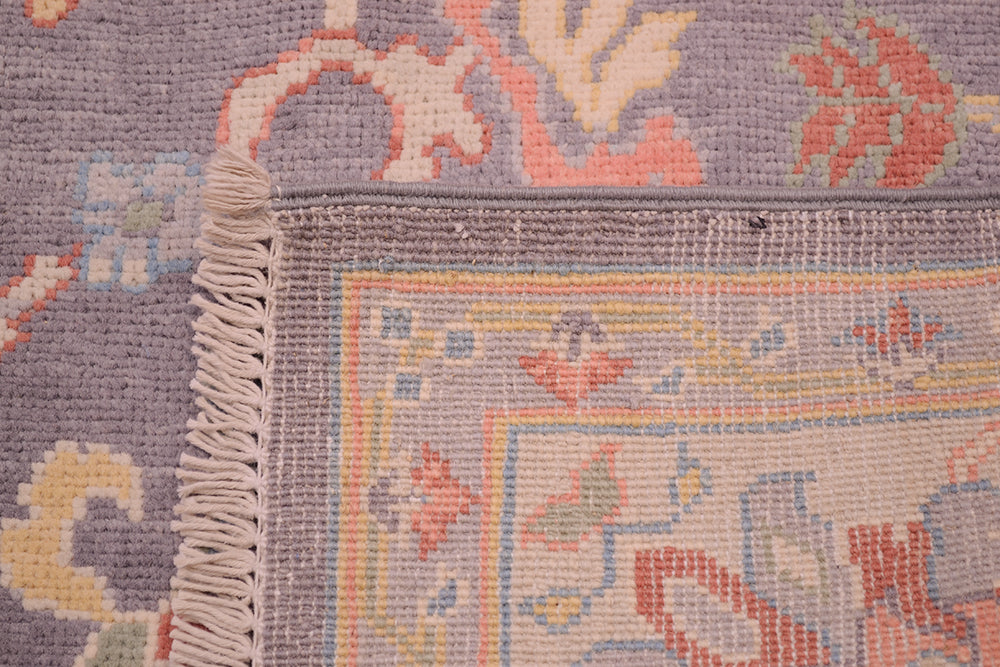 Reverse of Pastel and grey coloured handwoven carpet form Afghanistan.