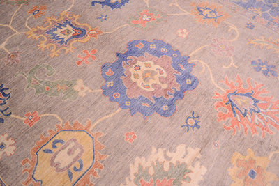 Detail of palmette of  pastel coloured Afghan Ushak carpet in blue, grey and soft corals