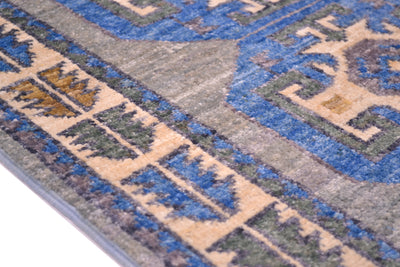 Detail of border of OUshak mat with stylized leaves in blue, green and amber.