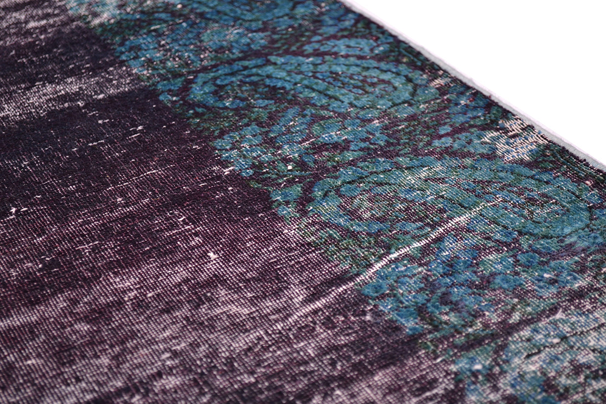 Detail of border of vintage overdyed hallway runner with boteh design with cut pile. Boteh and floral pattering in prussian blue, peacock teals; blues  and greens. Handknotted with cotton warp and wefts.