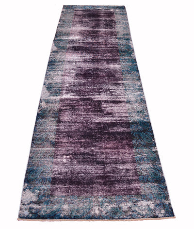 Overall view of vintage overdeyed carpe with ages distressed pile with deep aubergine coloured main centre field and border with  deep blue-green teal traditional boteh and floral-paisley patterning. High and low pile.