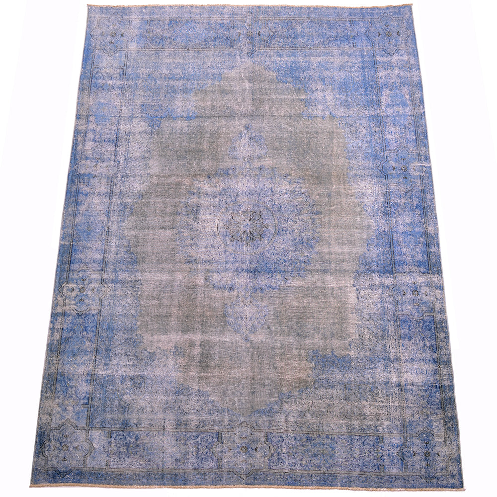 Vintage overdyed carpet in blue and grey with traditional border with geometric lobed medallions  Centralised motif a pendanted medallion. Atmospheric hues of greys and blues with zero distressed pile.