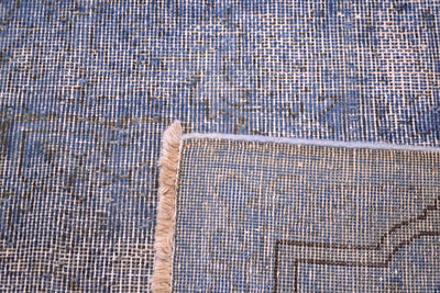 Reverse of vintage carpet with shaved  blue pile and dark charcoal detailing. Softened semi-floral geometric detailing.