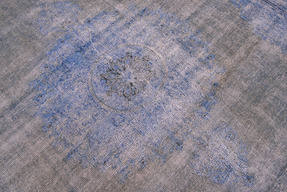 Floral medallion of blue and grey-brown overdyed carpet . Zero pile and warp and weft cotton foundation. vIntage caretps wioth traditional medallion design and overdyed. Circular medallion floral pattern.