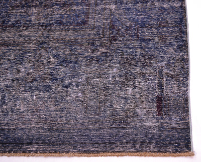 Deep aubergine and indigo tonalities of large vintage carpet with fine knotting and  artisanally shaved cut pile exposing historical orginal patternign and design.