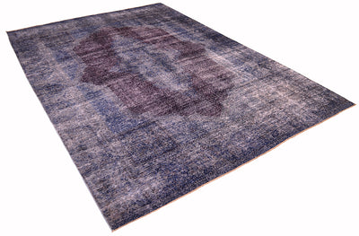 Angled view of Blue and deep teal blue- like tones vintage carpet with centralised motif in aubergine. Rich colouration and fine knotting. Shaved zero pile with sturdy cotton foundation. Classic design with modern colours.