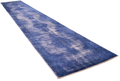 A long rectangular runner rug in a distressed blue and beige pattern, shown diagonally on a plain white background.