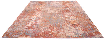 Impressive overall view of abstract modern indian carpet with soft easrthy tonalities. Terracotta, golds, ligth teals and blues  in raised silk as well as a background colour of stones and greys.