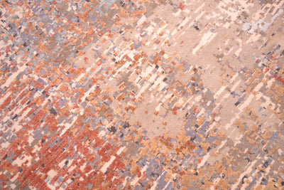 Close up view of detail of Indian modern carpet with wool colouors of taupe, grey and beige with raised silk highlights in gold-brone and terracotta.