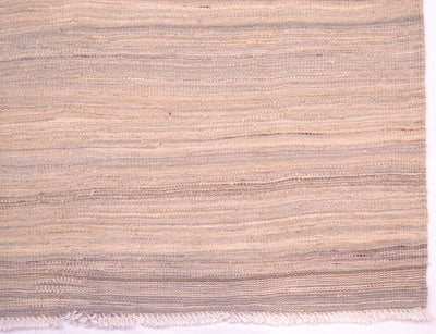 Detail of pastel abrash kilim with varying tones of blues, greys and creams with white cotton warp fringes.