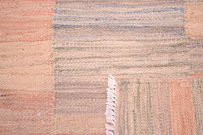 Detail showing both reversible sides of plainweave kilim rug in soft colours with natural dyes. 