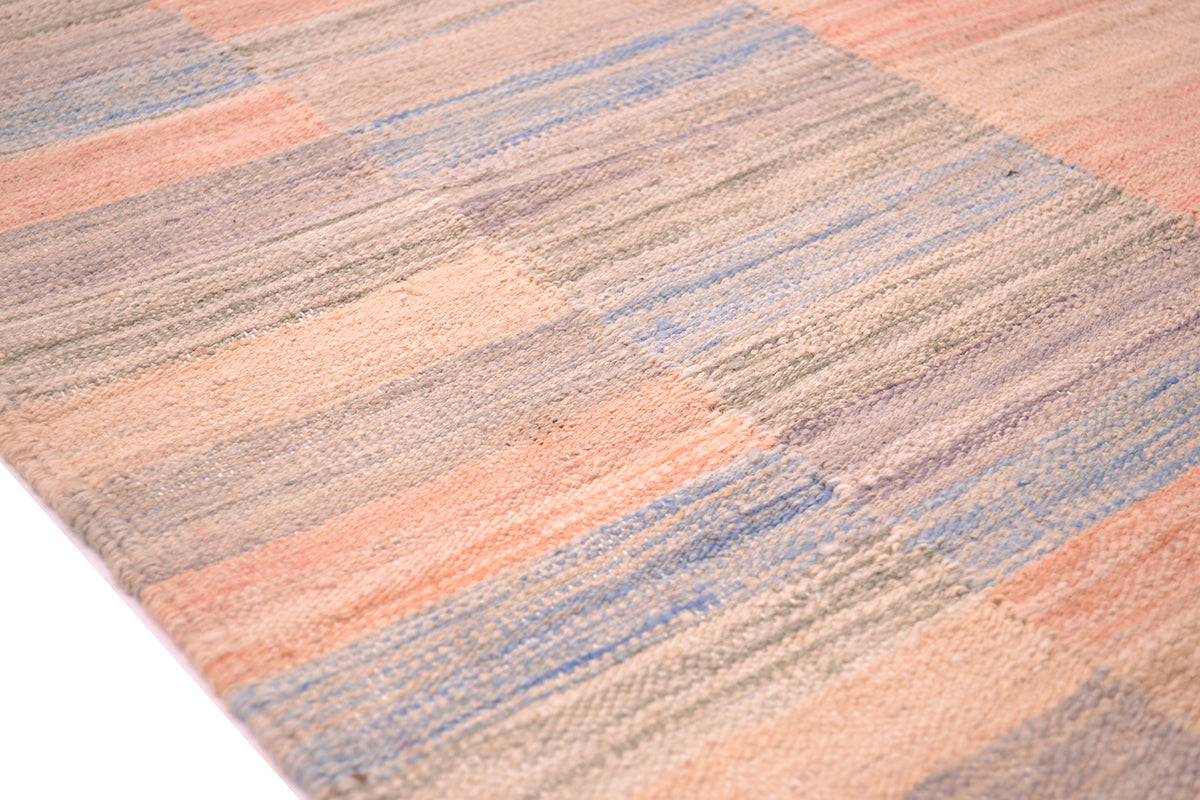 Detail of fine striped of pastel colured kilim with geometric striped format and overall soft colours. 