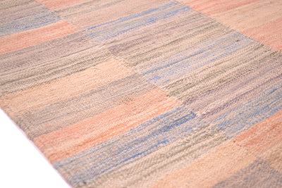 Detail of fine striped of pastel colured kilim with geometric striped format and overall soft colours. 