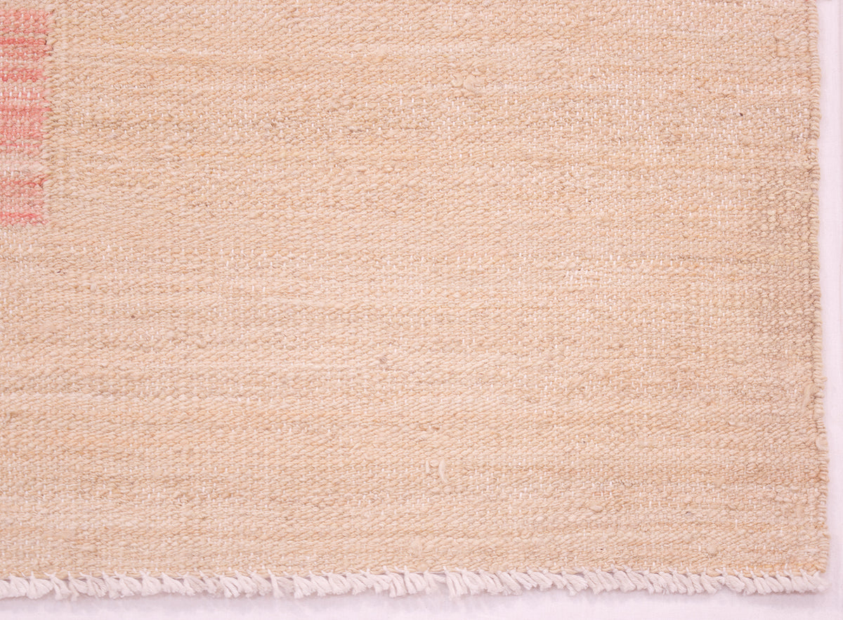 Close up detail of Afghan kilim with cream-beige weft threads and white cotton warps with cotton warp fringes.