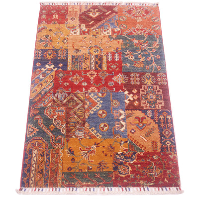 A 5x3 rectangular Afghan patchwork-style area rug with a multicolour geometric and floral pattern, featuring a red border and white fringe on the top and bottom, shown flat against a white background.
