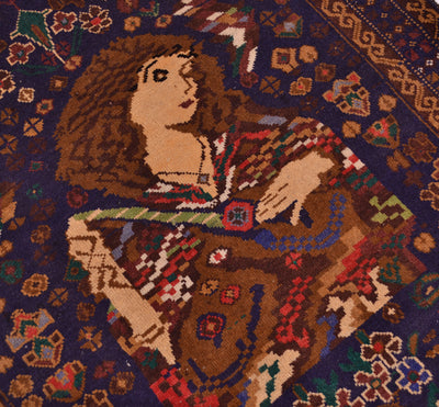 A close-up of a woven rug featuring a stylized seated woman in a patterned dress, surrounded by a dark blue floral design.