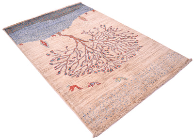 A rectangular Loribaft rug with a stylised tree design, featuring a beige centre, a blue patterned top section, and small bird motifs scattered across the surface.
