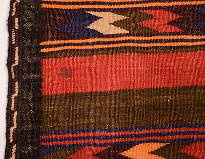 Close-up of a vintage handwoven Qala-i-Nau kilim runner rug showing a striped pattern with red, orange, dark brown, navy blue, and beige geometric accents.
