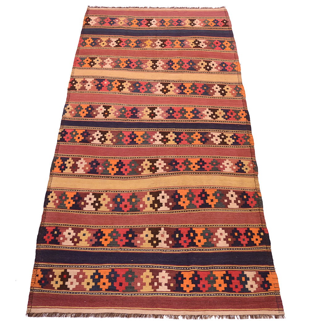 A handwoven rectangular kilim wool rug with a traditional geometric pattern, featuring horizontal stripes in red, orange, beige, brown, and dark blue, with fringed edges.