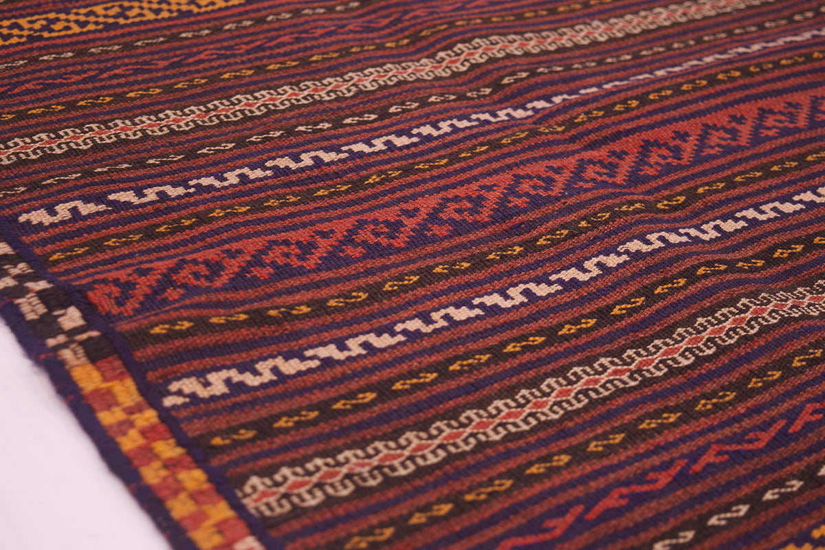 Vintage Kilim rug detail with woven texture and repeating geometric band patterns