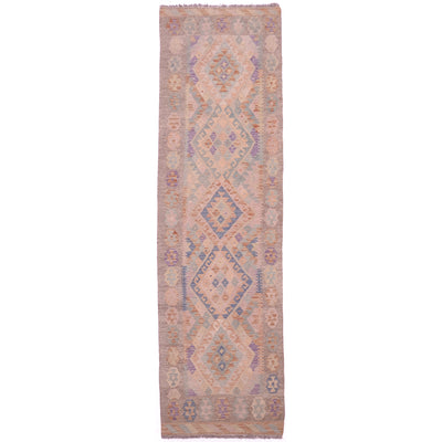 Handwoven soft colour Kilim runner with geometric design and faded washed out colours of beige, rust, green, blue and purple.