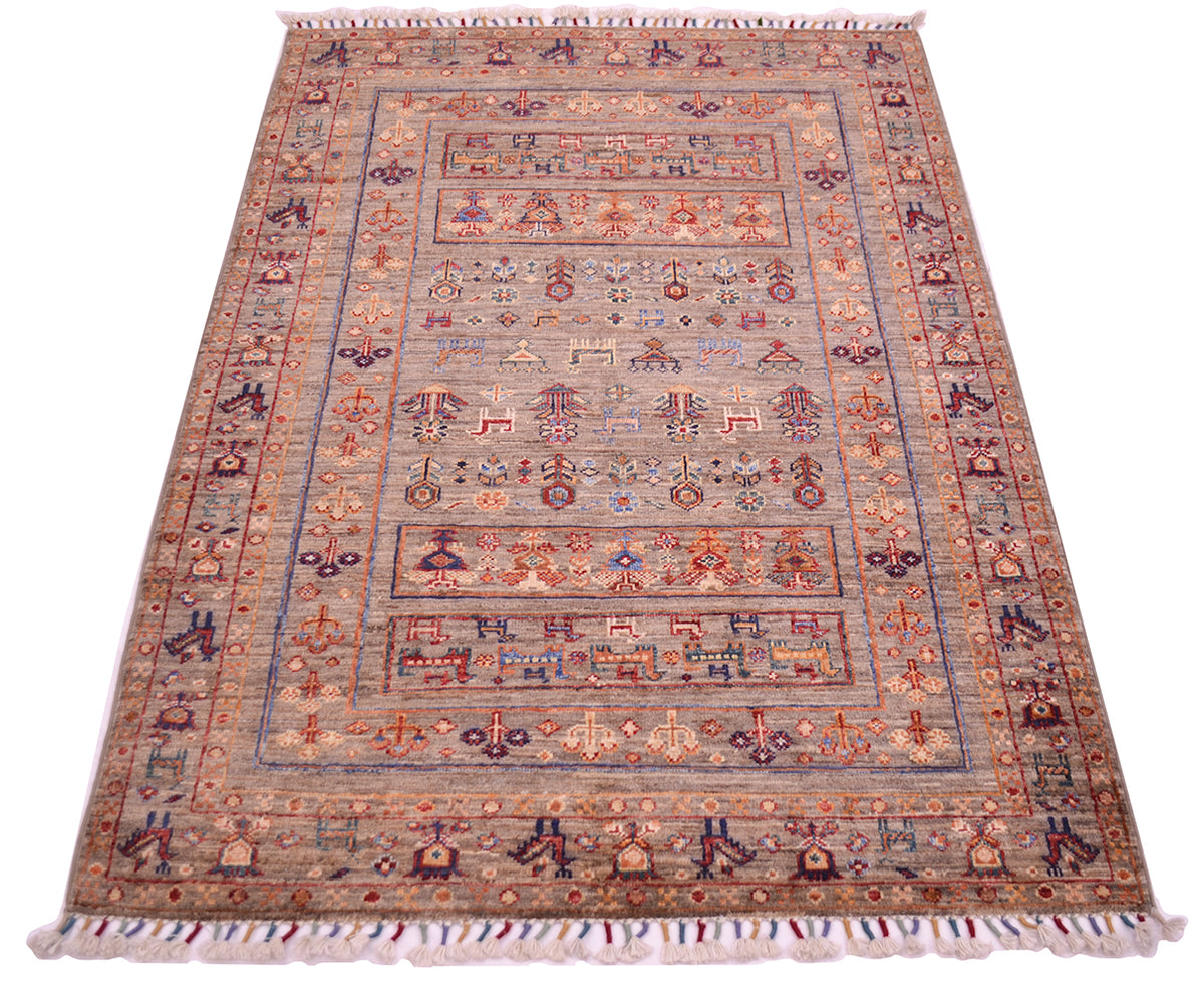 A modern Afghan-style handmade Samarkand rug with an intricate geometric and floral pattern, featuring a neutral grey-brown base with accents of terracotta, rust, and burgundy, finished with white and multicolour fringes on the ends.