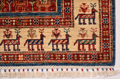 Bottom corner of small rug with cream field, repeated figures, and fringe detail