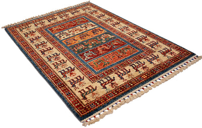 Folded small rug showing red, blue, and cream central medallion design