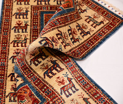 Small rug rolled edge showing cream field with red and blue geometric motifs