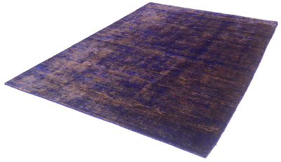 A rectangular area sari silk Indian rug with a distressed, vintage pattern in deep purple and brown tones, shown from an elevated angle on a white background.