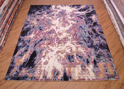 A handmade Abstract Modern Seismic carpet with classic carpet design fragmented and abstracted with purple, sky blues, sea blue and black disrupted by electrifying breaks of white and yellow-gold art silk. Curvilinear centre with border abstracted.