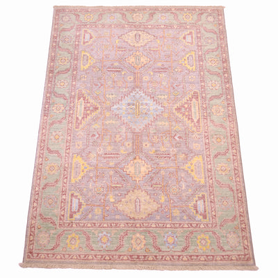 Handknotted geometric Serapi design rug with a light grey main field and light green border background. All over field with geometric format. 