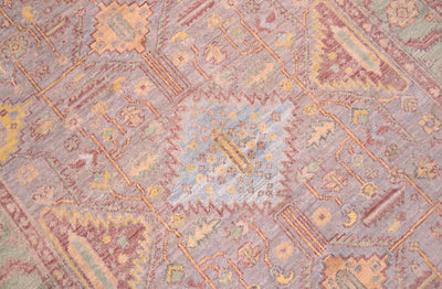 Close up detail of central device of Afghan Serapi rug with light blue central serrated medallion motif surrounded by a geometric network of stylized leaves and flowers adn yello detailing.