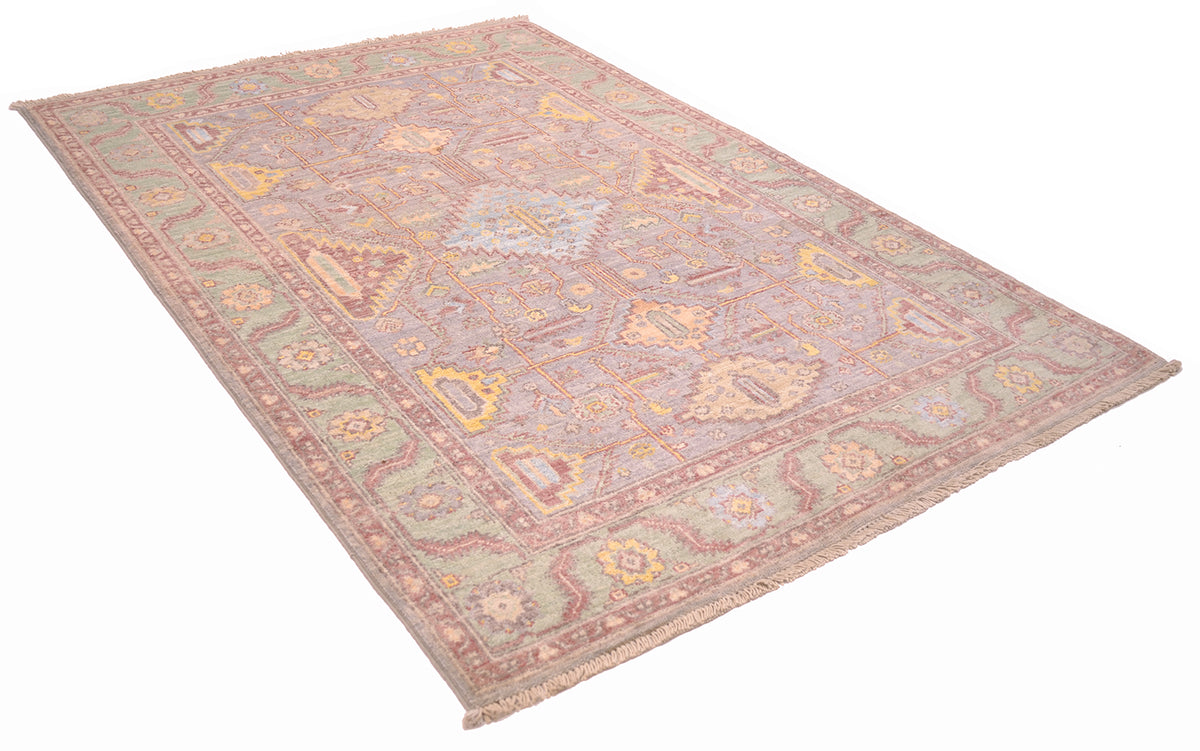 Angled view of Serapi rug handknotted in Afghanistan with geometric filed with branching appendages and stylized leaves. Connecting geometric medallions in main field. 