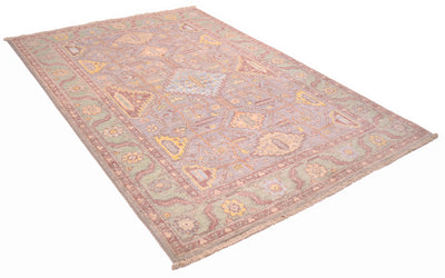 Angled view of Serapi rug handknotted in Afghanistan with geometric filed with branching appendages and stylized leaves. Connecting geometric medallions in main field. 