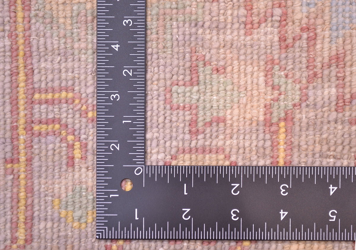 DEtail of reverse of rug showing handknotting of pure wool and soft tones created by natural vegetable dyes.