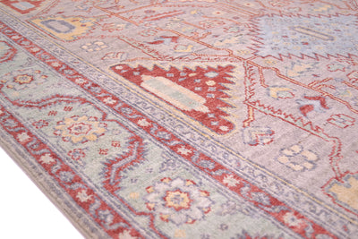 Detail of border of grey serapi rug with meabdering vine and rosette border with angualr serrated leaves  with green backgroun border and soft red minor borders. Geometric network of 
main field with stylised vines and flowers.