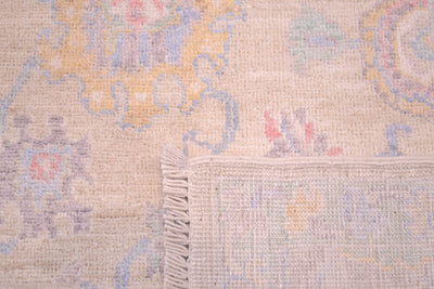 Detail of back of rug showing back of knots of handwoven rug and close up of field with delicate subtte colourways of soft hues. 