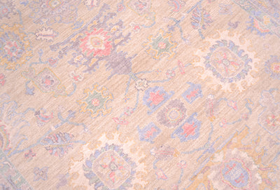 Detailed view of main field of Afghan Rug with Serapi design and all over floral motifs. Cream/ pale gold yellow field colour with accents of pink, blue, mauve grey and creamy white. 