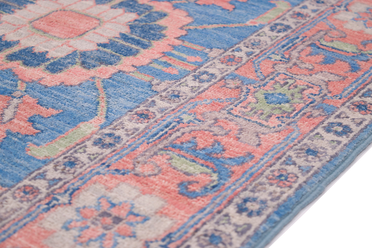 Detail of traditional cloudband border of Serapi design runner with pink, blue, light green and cream colourways.