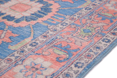 Detail of traditional cloudband border of Serapi design runner with pink, blue, light green and cream colourways.