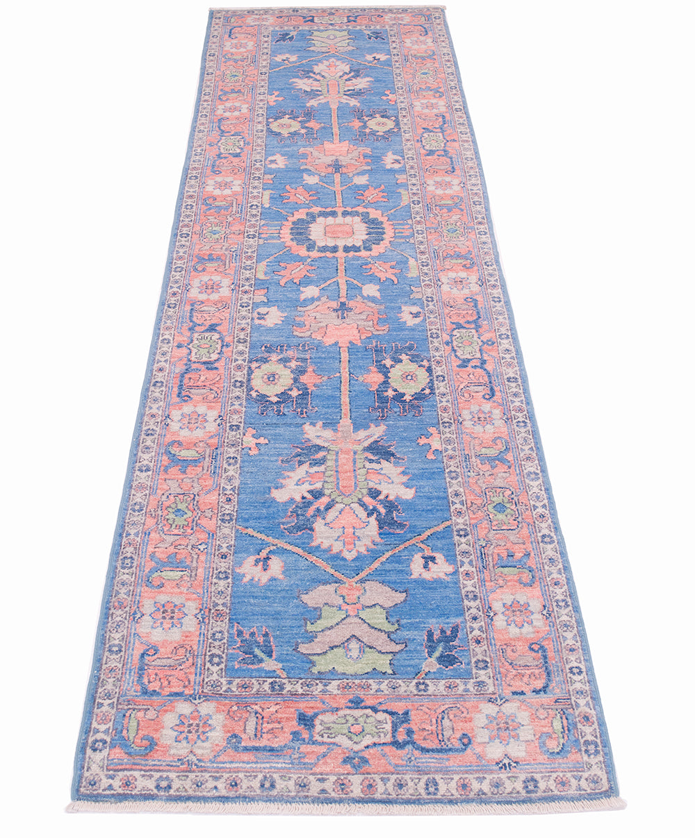 Blue and pink Afghan Serapi design runner rug with spacious floral appendages and central lobed medallion. Touches of green and cream ornamentation in field and border.