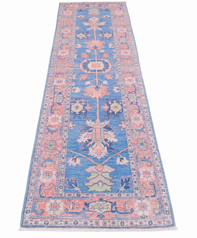 Blue and pink Afghan Serapi design runner rug with spacious floral appendages and central lobed medallion. Touches of green and cream ornamentation in field and border.